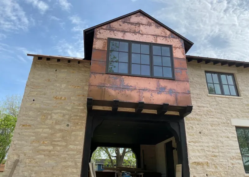 Copper metal panel facade on a stone building for Skylight Installation in Monee